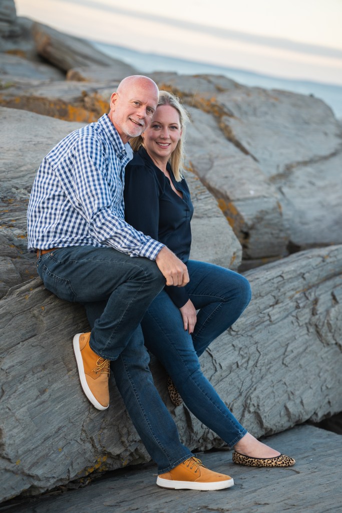 Couple sitting on rocks.